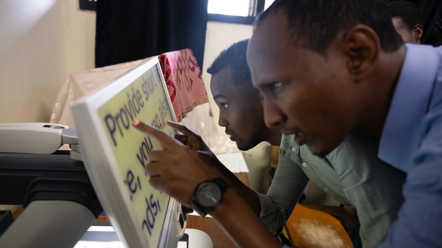 A photo of Abdulkadir Mohamed Abdullahi and Abdirahman Mohamud Kulane, take part in a visual exercise during a week-long training on braille production and digital inclusion at KyU Hi-Techn Center in Kampala, Uganda.