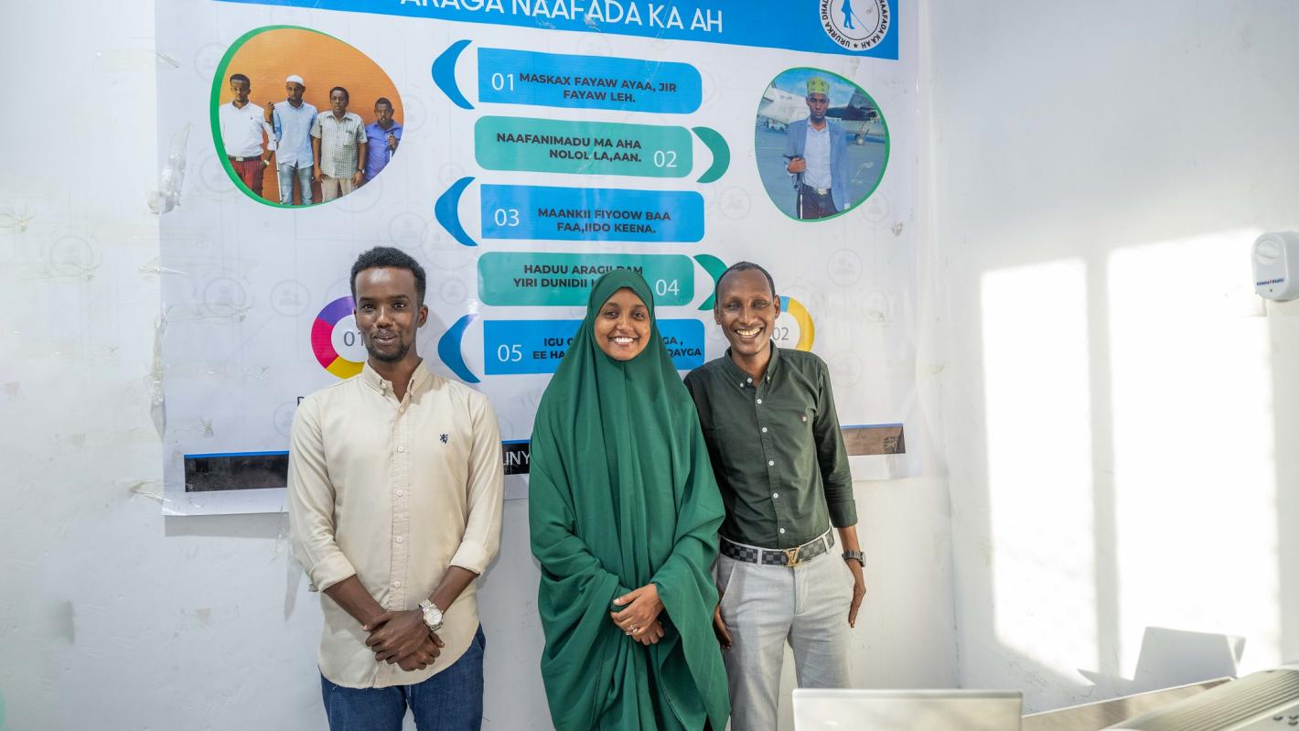 A photo of Abdirahman Mohamud Kulane (left), Abdulkadir Mohamed Abdullahi (right, and Hamdi Hussein Osman (middle), pose for a group photo in Mogadishu, Somalia.