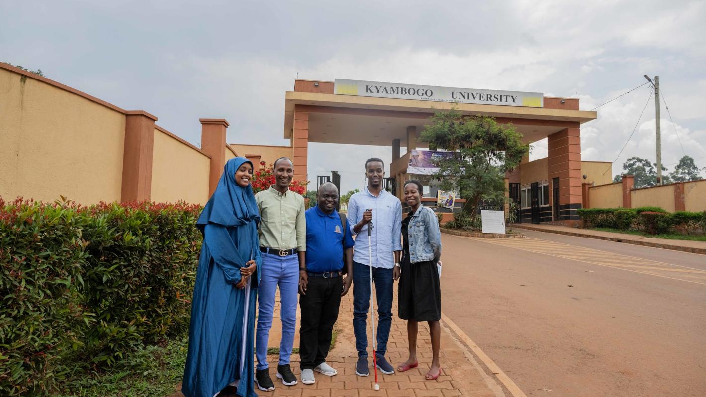 Kyebagadha Binsali, the Head of KyU Hi-Techn Center, and UDHAN team members pose for a group photo at the main gate of KyU in Kampala, Uganda.