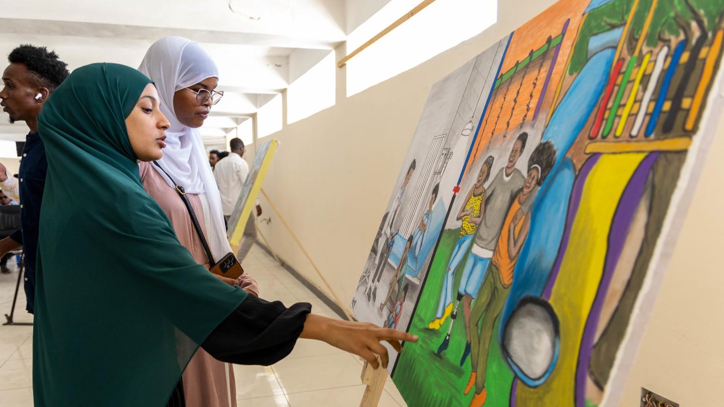 Guests view art paintings by Somali artists at an event commemorating International Universal Health Coverage Day at the National Museum in Mogadishu, Somalia, on 18 December 2024.