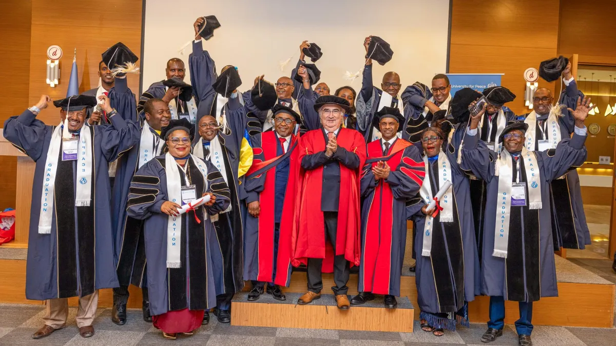 A group of graduates raise their mortarboards with UPEACE Senior officials at the fourth UPEACE graduation ceremony held in Mogadishu, Somalia, on 24 January 2025. A group of graduates raise their mortarboards with UPEACE Senior officials at the fourth UPEACE graduation ceremony held in Mogadishu, Somalia, on 24 January 2025.