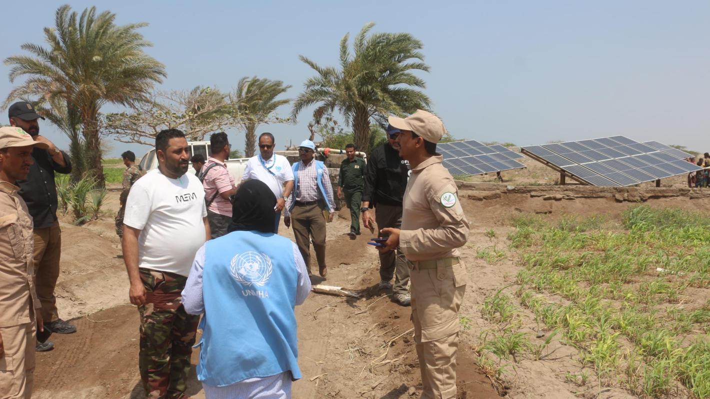 A group of people standing in the field