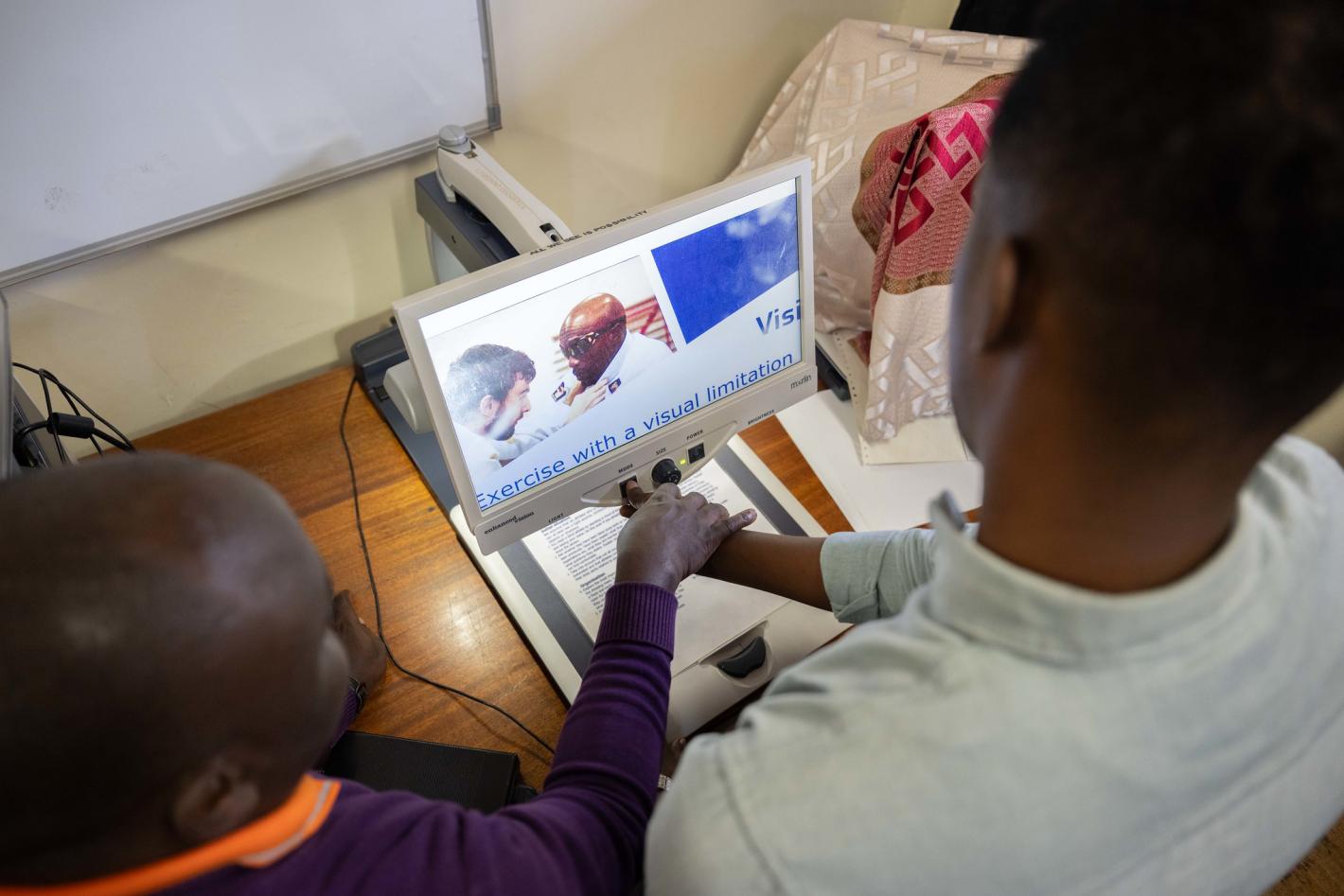 Photo of Abdirahman Mohamud Kulane, inspects one of the assistive tools during a week-long training on braille production and digital inclusion at KyU Hi-Techn Center in Kampala, Uganda.