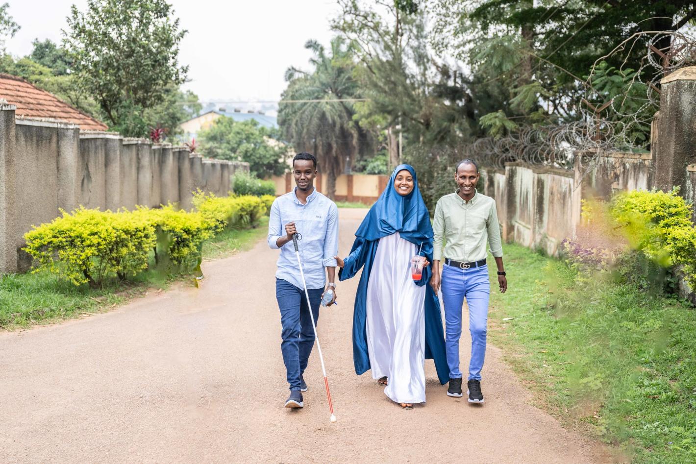 A photo of the UDHAN team strolling along a street in Kampala.