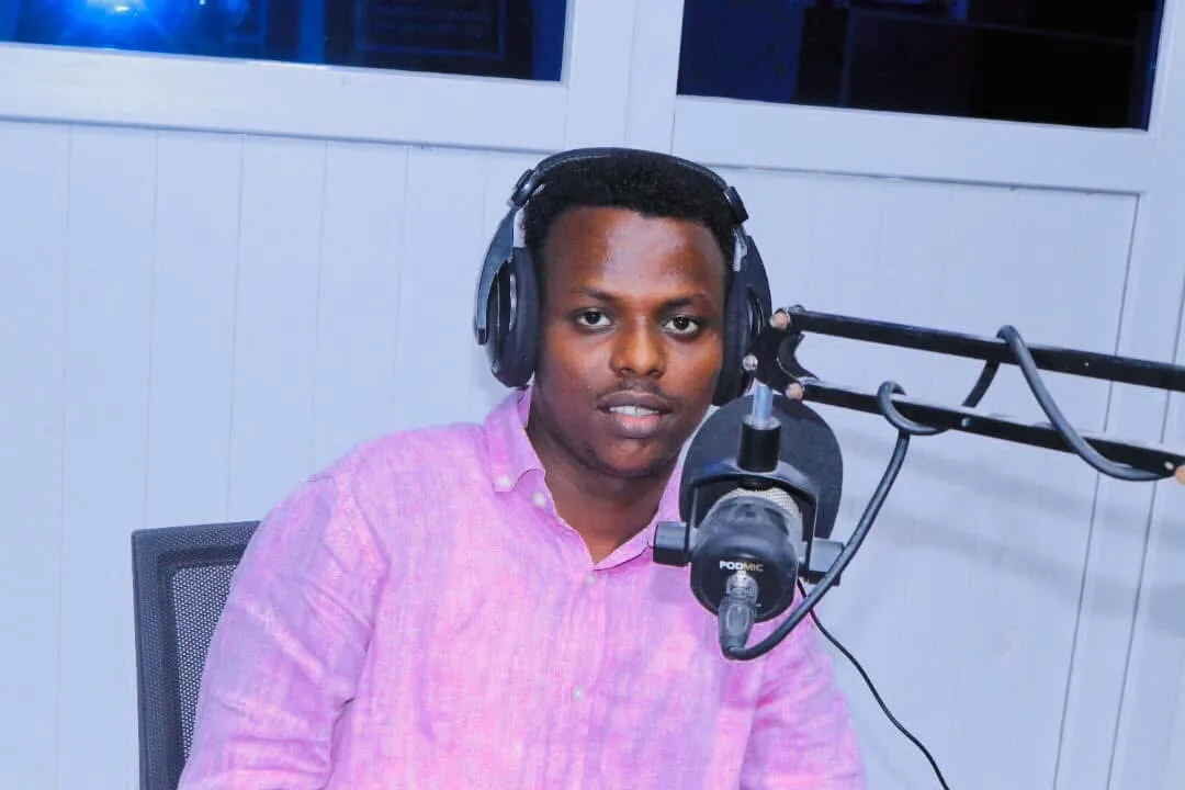 Abdishakur Abdirahman in front of a microphone wearing headphones Abdishakur Abdirahman in front of a microphone wearing headphones