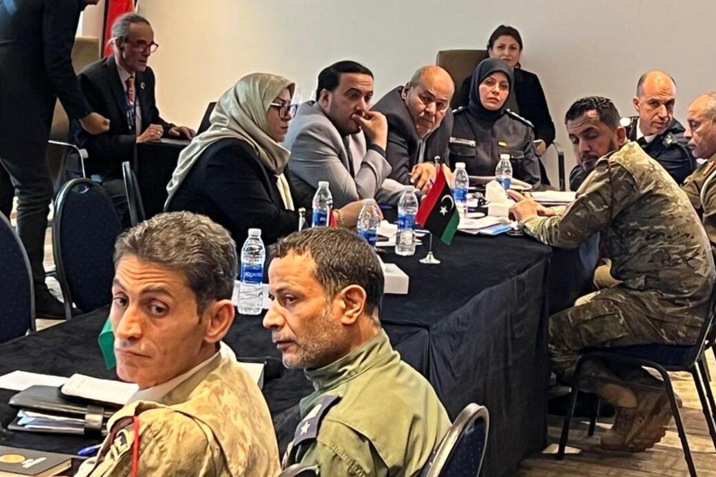 Photo of a group of men and women discussing the implementation plan of the security code of conduct 