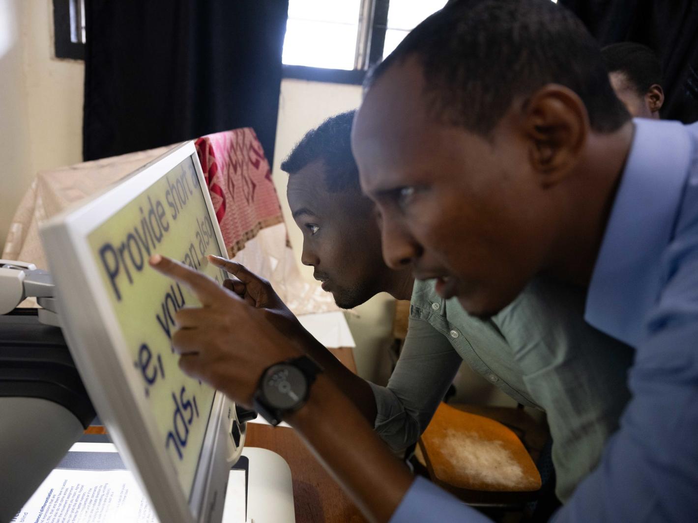 A photo of Abdulkadir Mohamed Abdullahi and Abdirahman Mohamud Kulane, take part in a visual exercise during a week-long training on braille production and digital inclusion at KyU Hi-Techn Center in Kampala, Uganda.