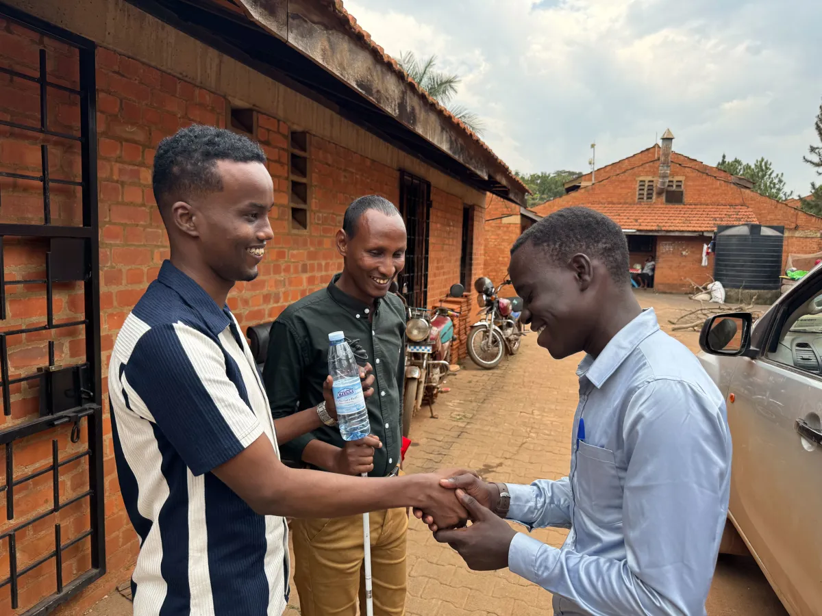 Abdirahman Mohamud Kulane and Abdulkadir Mohamed Abdullahi interacts with a visually impaired student at KyU Hi-Techn Center in Kampala, Uganda. Photo of Abdirahman Mohamud Kulane and Abdulkadir Mohamed Abdullahi interacts with a visually impaired student at KyU Hi-Techn Center in Kampala, Uganda.