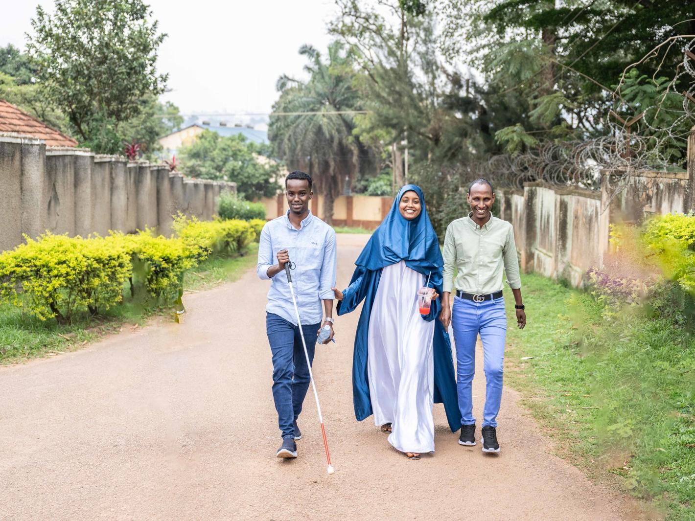 A photo of the UDHAN team strolling along a street in Kampala.