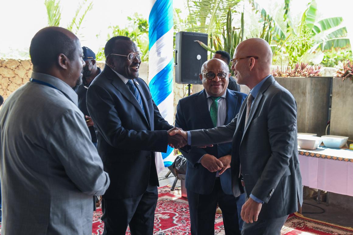Acting UN Special Representative James Swan shakes hands with Somalia's Minister of Family Affairs and Human Rights Development Lt. Gen. Bashir Mohamed Jama at the Open Day on Women, Peace and Security
