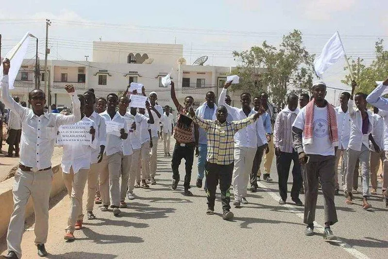 lively street demonstration featuring a group of young men marching together lively street demonstration featuring a group of young men marching together
